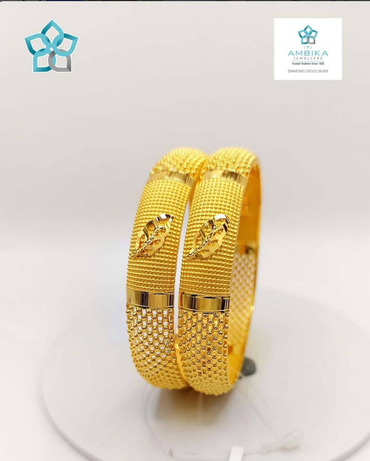 Pair of gold bangles with leaf design