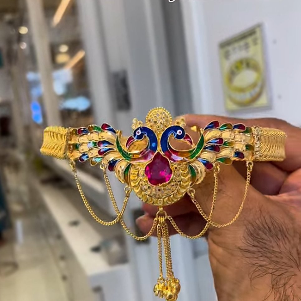 Gold peacock armlet with colourful enamel and stone